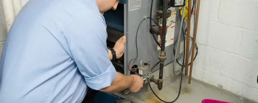 Furnace repair technician inspecting and servicing a home heating system in Jacksonville, FL