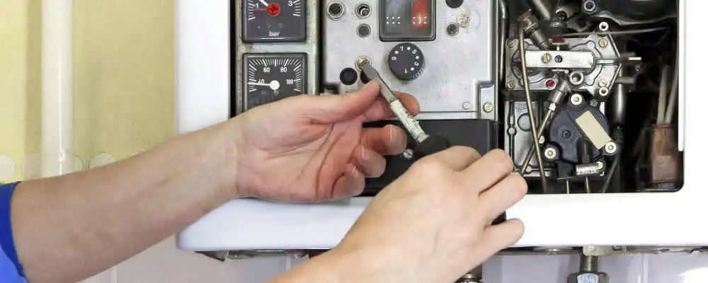 Heating repair technician adjusting boiler controls and components in Jacksonville, FL