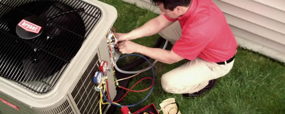 HVAC technician servicing an outdoor air conditioner unit in Jacksonville, FL