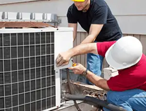HVAC technicians repairing an outdoor AC unit on a rooftop in Jacksonville, FL
